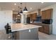 Spacious kitchen with a large island, modern appliances, and stylish lighting fixtures at 6486 Vanhoven Crest St, Las Vegas, NV 89166