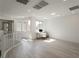 Bright living area with large windows, white walls, hardwood floors, and modern desk at 6486 Vanhoven Crest St, Las Vegas, NV 89166