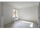 Bright living room with white walls, wood-look floors, and a modern keyboard by the window at 6486 Vanhoven Crest St, Las Vegas, NV 89166