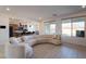 Open-concept living area featuring an island with barstool seating and views of the gourmet kitchen at 6486 Vanhoven Crest St, Las Vegas, NV 89166