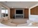 Stylish living room with modern fireplace, wood accent wall, and sleek tile flooring at 6486 Vanhoven Crest St, Las Vegas, NV 89166