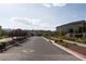 Street view of homes inside a gated community with landscaping and entrance sign at 6486 Vanhoven Crest St, Las Vegas, NV 89166