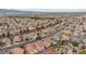 Extensive aerial view of a neighborhood with mature landscaping and ample street parking at 672 Hitchen Post Dr, Henderson, NV 89011