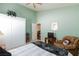 Cozy bedroom featuring plush chair, television, closet, and soothing green walls at 672 Hitchen Post Dr, Henderson, NV 89011