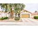 Charming single-story home with a well-manicured front yard and a two-car garage at 672 Hitchen Post Dr, Henderson, NV 89011