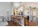 Open kitchen with granite countertops, wood floors, and a breakfast bar at 672 Hitchen Post Dr, Henderson, NV 89011
