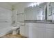 Bright bathroom featuring a tub shower, white vanity with granite countertop, and wood-look flooring, perfect for relaxation at 6800 E Lake Mead Blvd # 2072, Las Vegas, NV 89156