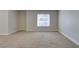 Bright bedroom features neutral walls, plush carpet, and a window bringing in natural light at 6800 E Lake Mead Blvd # 2072, Las Vegas, NV 89156