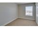Cozy bedroom with plush carpet, natural light from the window, and ample closet space creating a serene atmosphere at 6800 E Lake Mead Blvd # 2072, Las Vegas, NV 89156