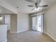 Cozy living room featuring neutral walls, carpet, a modern ceiling fan, and a sliding glass door to the outside at 6800 E Lake Mead Blvd # 2072, Las Vegas, NV 89156