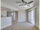 Bright living room featuring neutral walls, carpet, a modern ceiling fan, and a sliding glass door to the outside at 6800 E Lake Mead Blvd # 2072, Las Vegas, NV 89156