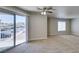 Inviting living room featuring neutral walls, carpet, a modern ceiling fan, and a sliding glass door to the outside at 6800 E Lake Mead Blvd # 2072, Las Vegas, NV 89156