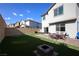 Grassy backyard with a brick patio, outdoor furniture, and a well-maintained lawn at 7037 Tilligerry St, North Las Vegas, NV 89084