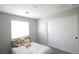 Bright bedroom featuring a twin bed, closet, and neutral decor with gray carpet and natural lighting at 7037 Tilligerry St, North Las Vegas, NV 89084