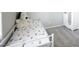 Comfortable bedroom with a twin bed, soft carpet, and charming white wardrobe for storage at 7037 Tilligerry St, North Las Vegas, NV 89084
