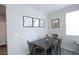 Cozy dining area with a dark wood table, upholstered chairs, and neutral decor at 7037 Tilligerry St, North Las Vegas, NV 89084