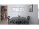 Cozy dining room with a gray table, four chairs, and wall decorations at 7037 Tilligerry St, North Las Vegas, NV 89084