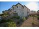 Two-story home with a two-car garage, desert landscaping, and a paver driveway at 7037 Tilligerry St, North Las Vegas, NV 89084