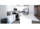 Well-lit kitchen showcasing a central island, stainless appliances, and sleek white cabinets at 7037 Tilligerry St, North Las Vegas, NV 89084