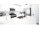 Modern kitchen with white cabinets, stainless steel appliances, and a quartz countertop island at 7037 Tilligerry St, North Las Vegas, NV 89084