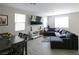 Comfortable living space featuring tile floors, a large sectional, and a dining table at 7037 Tilligerry St, North Las Vegas, NV 89084