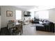 Bright living room with tile floors, modern furniture, and a dining area at 7037 Tilligerry St, North Las Vegas, NV 89084