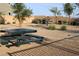 Community picnic area with picnic tables, a grill, and nearby landscaping; great for outdoor enjoyment at 7037 Tilligerry St, North Las Vegas, NV 89084