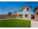 Low-maintenance backyard with artificial turf, bordered by gravel and a stucco privacy wall at 7124 Sayonara Vista St, North Las Vegas, NV 89084