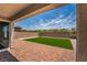 Paver patio leads to a well-manicured backyard with artificial turf, enclosed by a brick wall at 7124 Sayonara Vista St, North Las Vegas, NV 89084