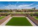 A view of the backyard with an artificial lawn, enclosed by a brick wall for added privacy at 7124 Sayonara Vista St, North Las Vegas, NV 89084