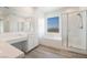 Bright bathroom features a soaking tub, separate shower and vanity with double sinks at 7124 Sayonara Vista St, North Las Vegas, NV 89084