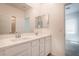 Bright bathroom with double sink vanity, white cabinets, and large mirrors at 7124 Sayonara Vista St, North Las Vegas, NV 89084