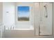 Clean, bright bathroom features a soaking tub and separate shower at 7124 Sayonara Vista St, North Las Vegas, NV 89084