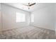 Bright bedroom with plush carpet, ceiling fan, and natural light from windows at 7124 Sayonara Vista St, North Las Vegas, NV 89084