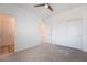 Bright bedroom features neutral carpet, ceiling fan, and double-door closet at 7124 Sayonara Vista St, North Las Vegas, NV 89084