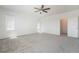 Spacious bedroom with neutral carpet, ceiling fan, and windows at 7124 Sayonara Vista St, North Las Vegas, NV 89084