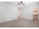 Large bedroom with neutral carpet, ceiling fan, and walk-in closet at 7124 Sayonara Vista St, North Las Vegas, NV 89084