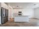 Bright kitchen features white cabinets, granite countertops, stainless steel appliances and a central island at 7124 Sayonara Vista St, North Las Vegas, NV 89084