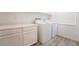 Bright laundry room with countertop, cabinets, and washer/dryer at 7124 Sayonara Vista St, North Las Vegas, NV 89084