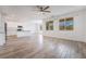 Bright and airy living room with wood-style flooring and an open-concept layout, adjacent to the kitchen and dining area at 7124 Sayonara Vista St, North Las Vegas, NV 89084