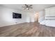 Spacious living room with modern flooring, TV, and stairs leading to the upper level, for a comfortable living experience at 7124 Sayonara Vista St, North Las Vegas, NV 89084