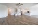 Open-concept living room featuring wood-style flooring and a seamless transition into the kitchen and dining area at 7124 Sayonara Vista St, North Las Vegas, NV 89084