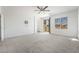 Spacious main bedroom with neutral carpet, ceiling fan and sliding glass door to balcony at 7124 Sayonara Vista St, North Las Vegas, NV 89084