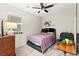 Cozy bedroom with a ceiling fan, dresser, comfortable chair, and decor creating a relaxing and inviting space at 7502 Lush Oasis Ave, Las Vegas, NV 89113