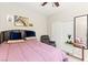Inviting bedroom features a queen-size bed, recliner, closet, accent table, and stylish decor at 7502 Lush Oasis Ave, Las Vegas, NV 89113