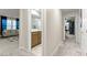 Hallway view showcasing bathroom and living area, offering a glimpse of the home's layout and design at 7502 Lush Oasis Ave, Las Vegas, NV 89113
