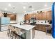 Bright kitchen with an island, pendant lighting, and wooden cabinets at 7502 Lush Oasis Ave, Las Vegas, NV 89113