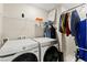 This laundry room features modern Samsung washer and dryer units, as well as storage shelving at 7502 Lush Oasis Ave, Las Vegas, NV 89113