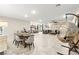 Open-concept living area with dining space, kitchen island, and stylish furnishings at 7502 Lush Oasis Ave, Las Vegas, NV 89113