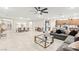 Bright open floor plan showcasing a large living room, dining area, and kitchen at 7502 Lush Oasis Ave, Las Vegas, NV 89113